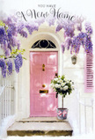 The image evokes a serene Kentish Town entrance, suspended in that gentle hush that follows a big life change. A front door painted in muted, powdered pink stands slightly recessed within a whitewashed façade, its colour soft yet sure, like a thoughtful choice made after many paint samples. Beside it, a matching pastel shutter subtly echoes the shade, creating a calm, cohesive frame. Above, wisteria trails down in flowing curtains of lavender and pale lilac, each stem heavy with tiny, bell-shaped blossoms that cluster together to form soft, pendulous garlands. The effect is both romantic and comforting, as though the blooms have been growing here for years, watching neighbours come and go along nearby Kentish Town Road or around the quieter streets leading to Hampstead Heath. On the doorstep, a simple grey florist's bucket is transformed into a focal point by the abundance it holds: white and cream roses, tightly grouped and sumptuously full, their velvety petals layered in delicate spirals. Wisps of fresh green foliage thread through the roses, lifting the arrangement and adding lightness without breaking the restrained palette. Around the base, a satin-like pink ribbon is tied with just enough flourish to feel celebratory but never fussy, mirroring the soft tones of the door. The light in the scene is gentle, casting minimal shadows and letting the colours speak in low, reassuring tones. Everything about this doorway suggests a housewarming story in NW5, perhaps a bouquet delivered by a local florist and left on the step to welcome its new owners home with grace, tenderness, and the promise that their days here will be framed by beauty and quiet joy.